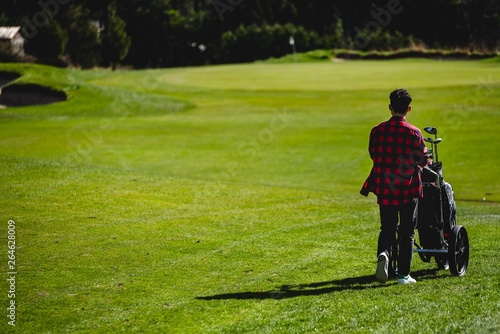 A young man walking on a golf course  © Vlad