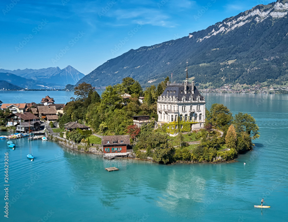 Castle on small island surrounded by azure blue water on the Brienzersee in Switzerland