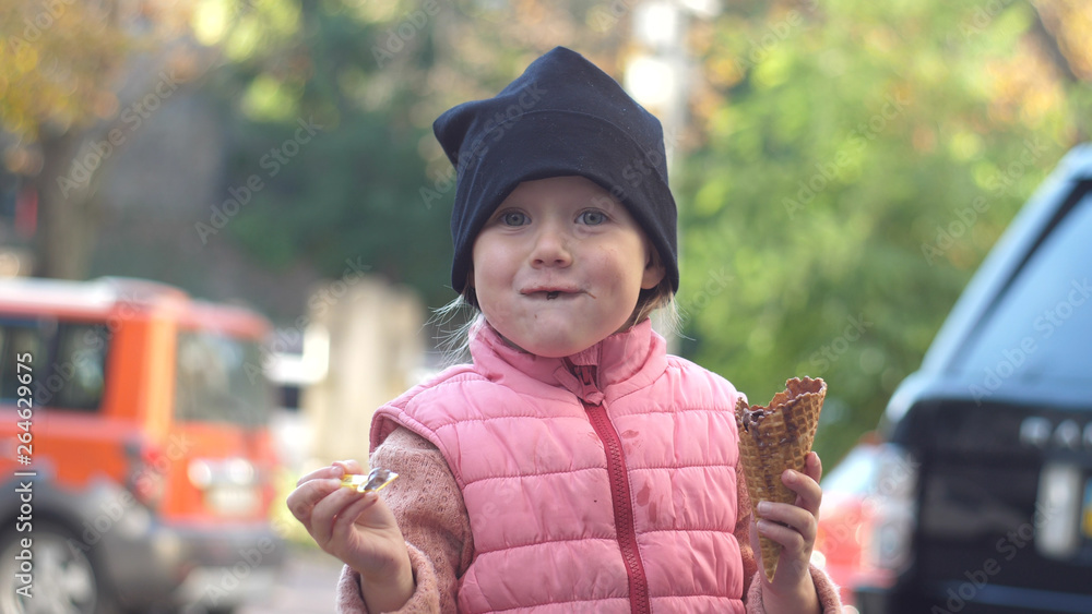 Pretty girl eating an ice cream outdoors. Pretty girl eating an ice cream outdoors.