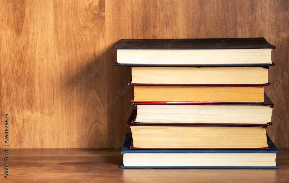 Pile of closed books on wooden shelf. Pile of closed books on wooden shelf.