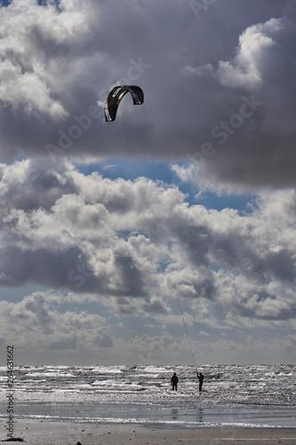 Kitesurfers on the shore ending their surfing session