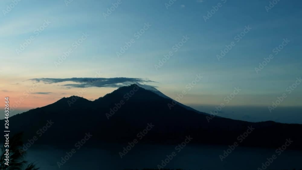 Sunrise view from Gunung Batur volcano in Bali with visible Mount Agung volcano Sunrise view from Gunung Batur volcano in Bali with visible Mount Agung volcano