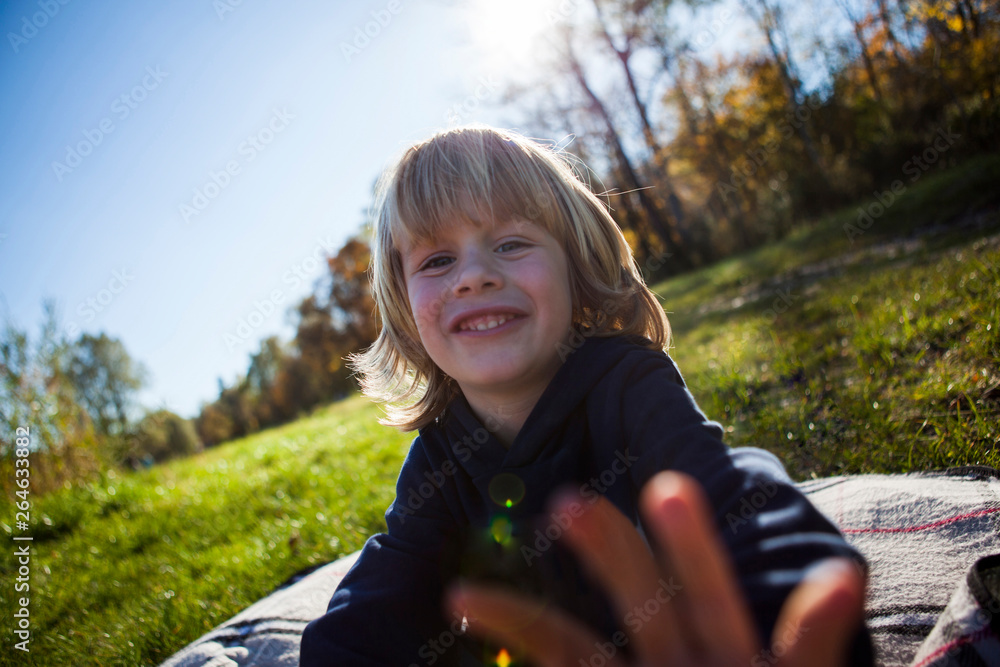 Portrait of smiling little boy on blanket outdoors Portrait of smiling little boy on blanket outdoors