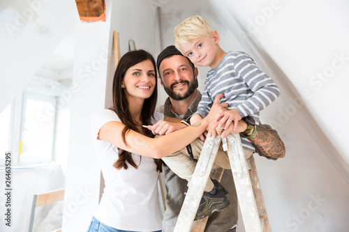 Portrait of happy family working on loft conversion