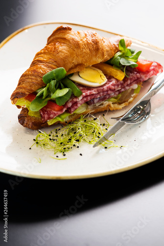 Reform croissant sandwich on a tendy plate. Gourmet conception.