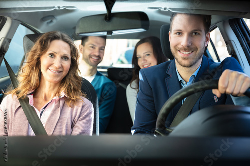 Smiling People Sitting In Car photo