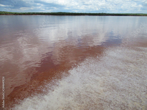Rainclouds over the Betsiboka River delta in northern Madagascar. River is red colored due to the eroded soil. photo