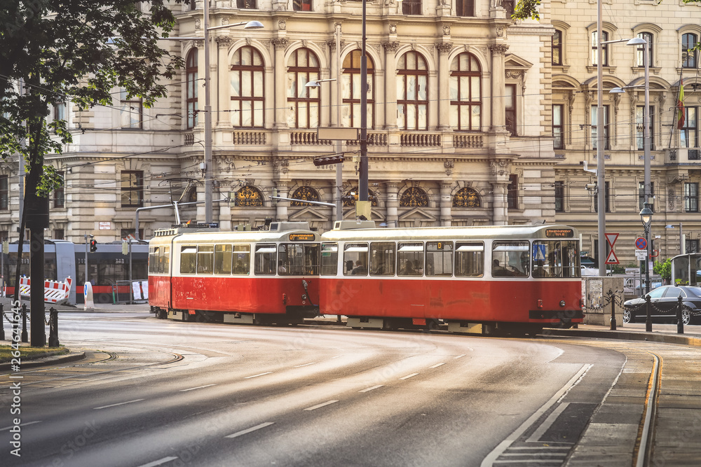 Fototapeta Old fashioned tram goes by the street of Vienna