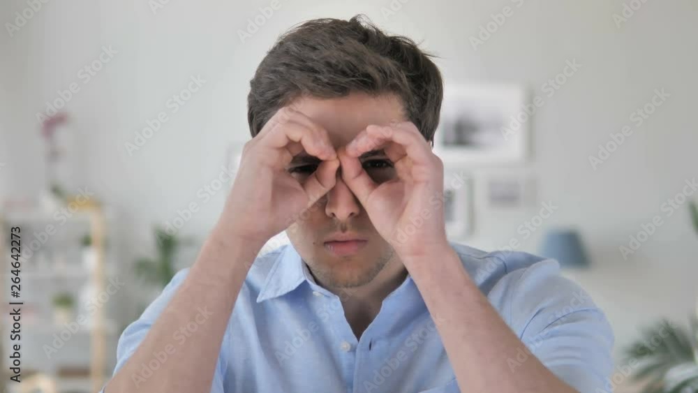 Handmade Binocular Gesture by Handsome Young Man Searching New Chance Handmade Binocular Gesture by Handsome Young Man Searching New Chance