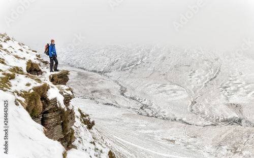 UK, Wales, Brecon Beacons, Craig y Fan Ddu, woman hiking in winter landscape photo