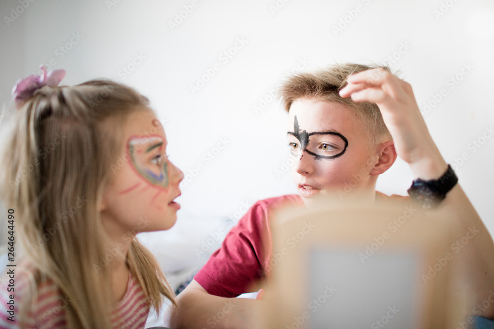 Brother and sister preparing for carnival Brother and sister preparing for carnival