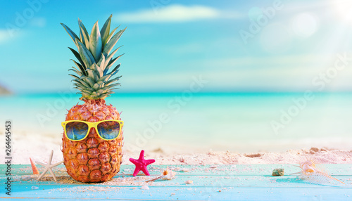 Pineapple With Sunglasses In The Beach photo