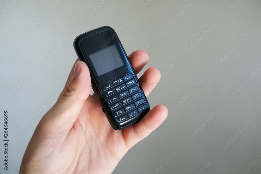 Close-up of man hand holding old black mobile phone Close-up of man hand holding old black mobile phone