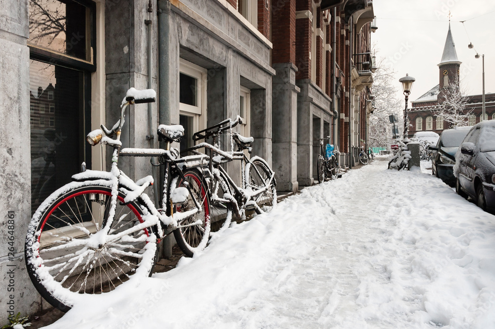 Snow-covered streets in Amsterdam during a cold winter in the Netherlands. Snow-covered streets in Amsterdam during a cold winter in the Netherlands.