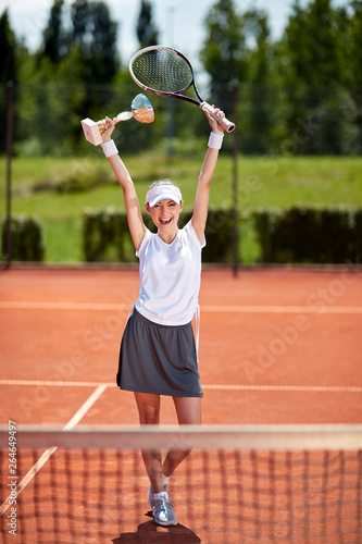 Winner in tennis match on tennis court © luckybusiness