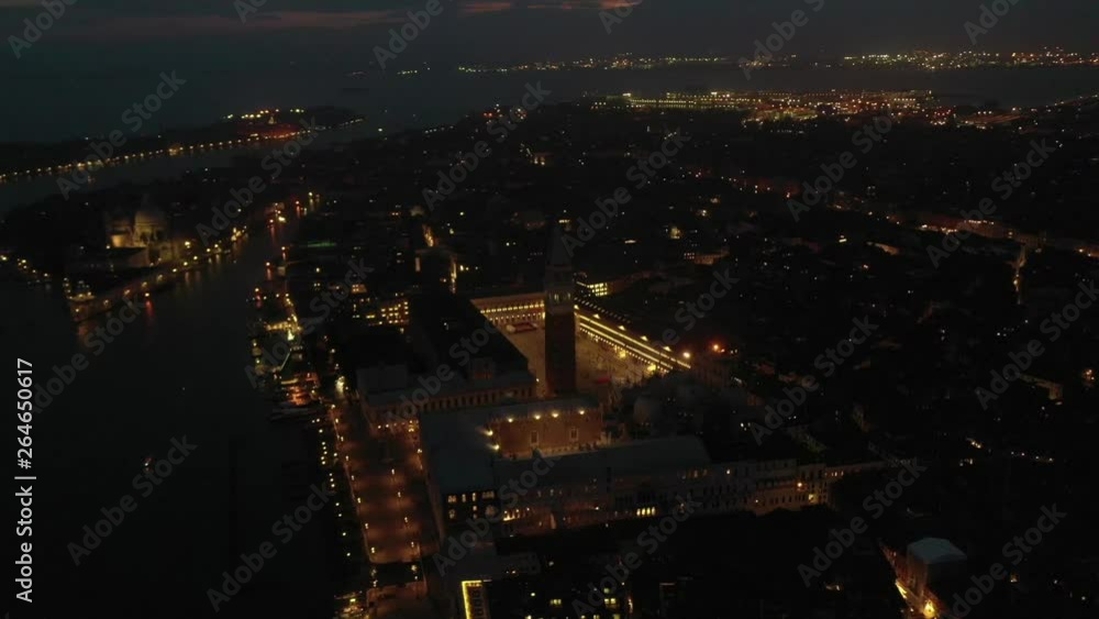Aerial drone night video of iconic illuminated Saint Mark's square or Piazza San Marco featuring Doge's Palace, Basilica and Campanile, Venice, Italy Aerial drone night video of iconic illuminated Saint Mark's square or Piazza San Marco featuring Doge's Palace, Basilica and Campanile, Venice, Italy