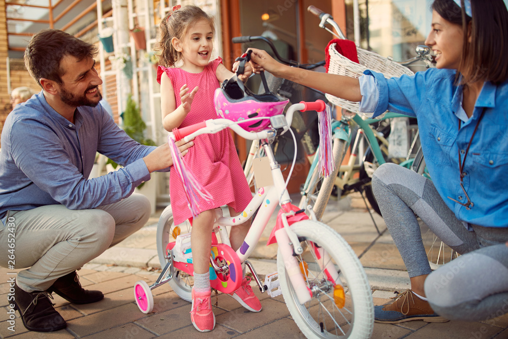 Fototapeta premium father buy daughter new bicycle in bike shop.