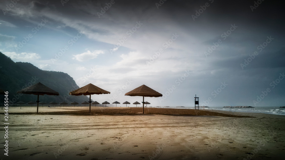 Ombrelloni di paglia sulla spiaggia pronti per la stagione estiva a Pesaro nella regione Marche in Italia