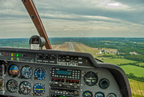 a view from the cockpit of a sports aircraft to the runway of an airfield