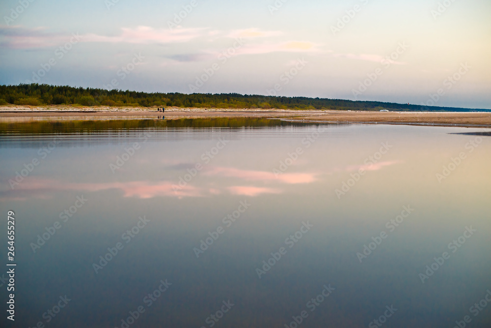 Fototapeta premium Baltic sea, perfect reflection, forest during sunset