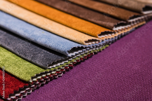 Colorful and bright fabric samples of furniture and clothing upholstery. Close-up of a palette of textile abstract stripes of different colors
