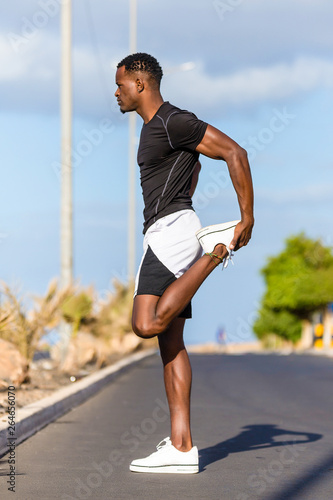 Black african american young man stretching after outdoor jogging © Samuel B.
