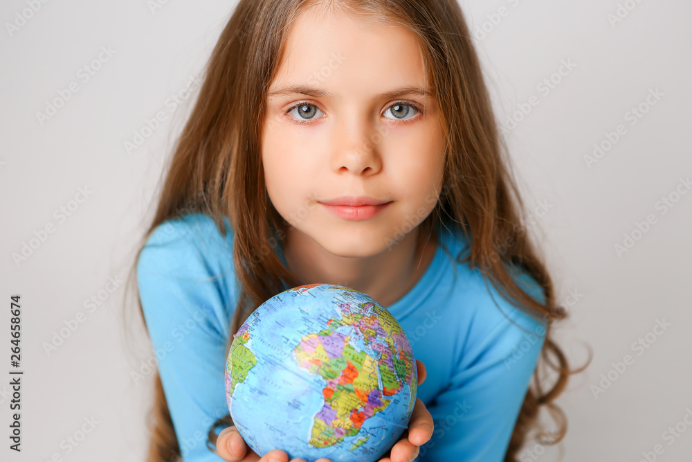 baby girl in blue dress holding globe, concept of environmental protection baby girl in blue dress holding globe, concept of environmental protection