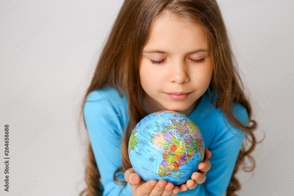 baby girl in blue dress holding globe, concept of environmental protection baby girl in blue dress holding globe, concept of environmental protection