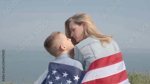 young woman with her son holding an american flag