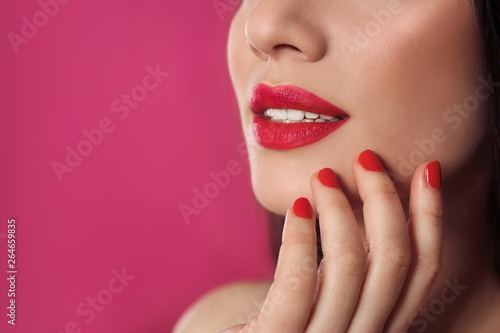 Beautiful woman with stylish nail polish on color background  closeup. Space for text