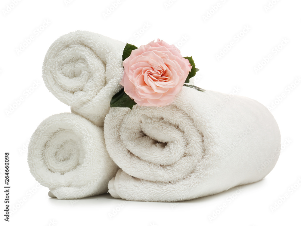 Clean rolled towels with flower on white background Clean rolled towels with flower on white background