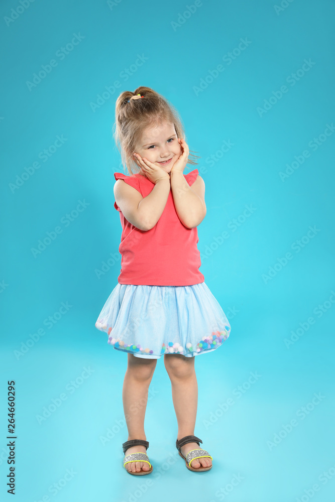 Full length portrait of cute little girl against color background Full length portrait of cute little girl against color background