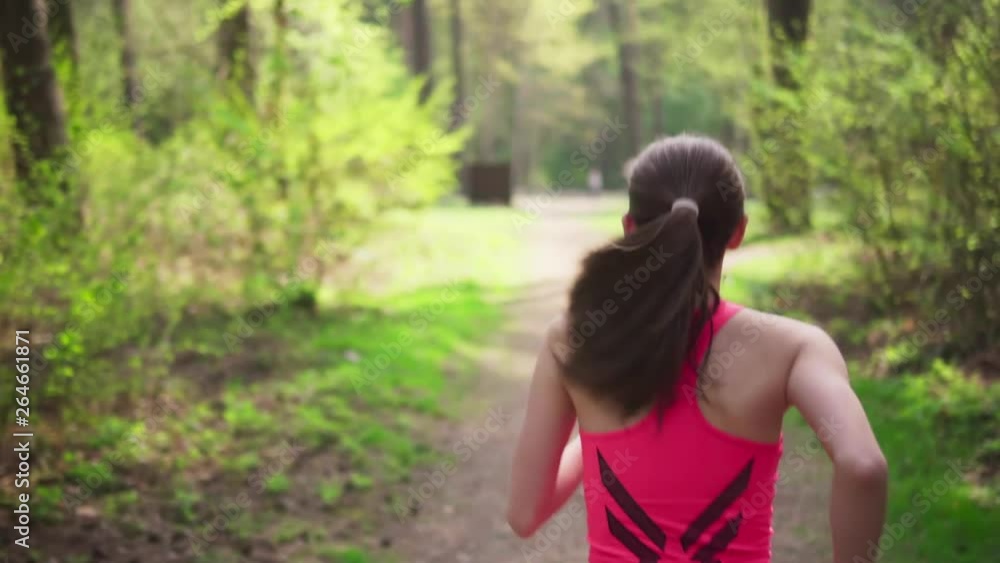 Active woman running in spring sunny forest Active woman running in spring sunny forest