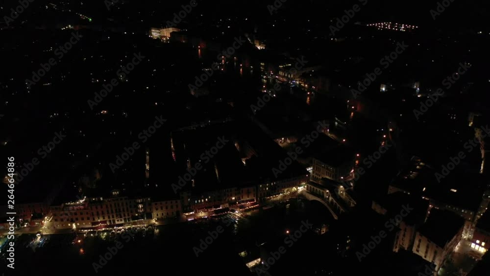 Aerial night video of iconic illuminated Ponte Rialto or Rialto bridge crossing Grand Canal, Venice, Italy Aerial night video of iconic illuminated Ponte Rialto or Rialto bridge crossing Grand Canal, Venice, Italy