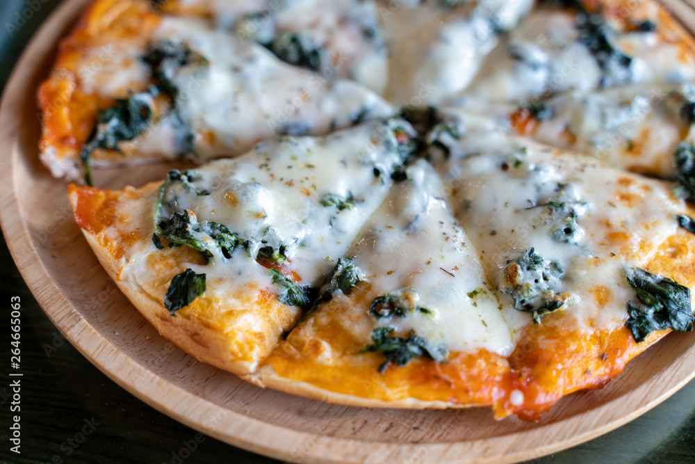 Delicious hot homemade pizza served on wooden plate. Delicious hot homemade pizza served on wooden plate.