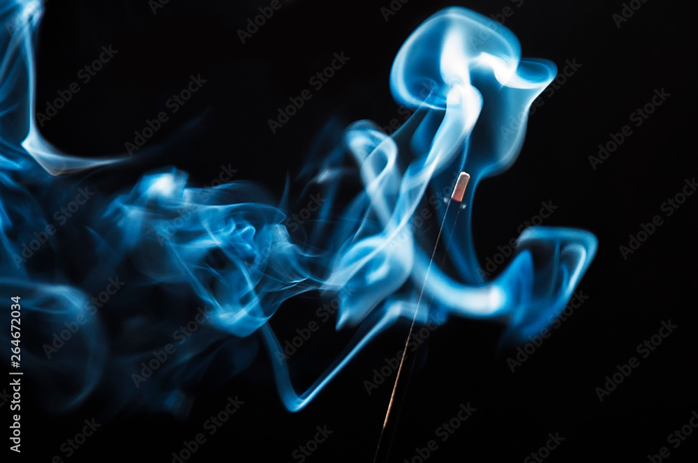 Fototapeta premium blue smoke of incense on black background
