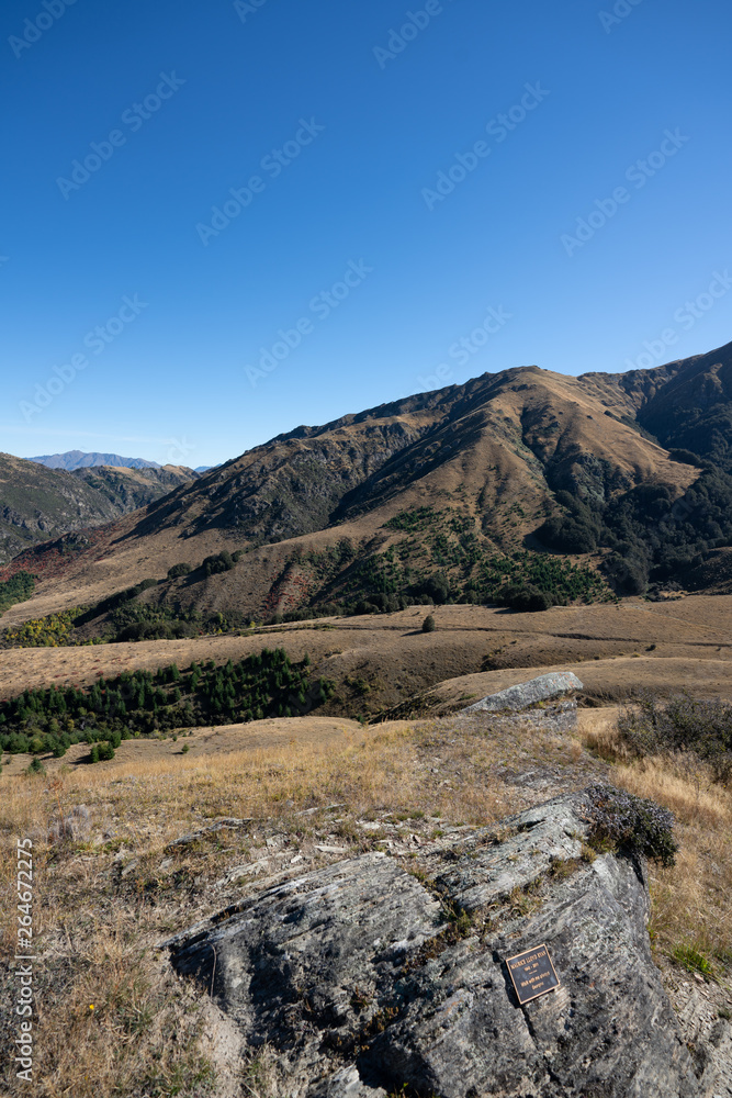 The rolling hills of Arrowtown in New Zealand at the start of Autumn