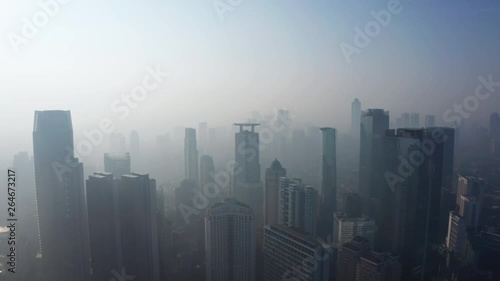 Wallpaper Mural JAKARTA, Indonesia - April 25, 2019: Beautiful aerial view of Jakarta city with silhouette of skyscrapers behind smog on the morning. Shot in 4k resolution from a drone flying forwards Torontodigital.ca