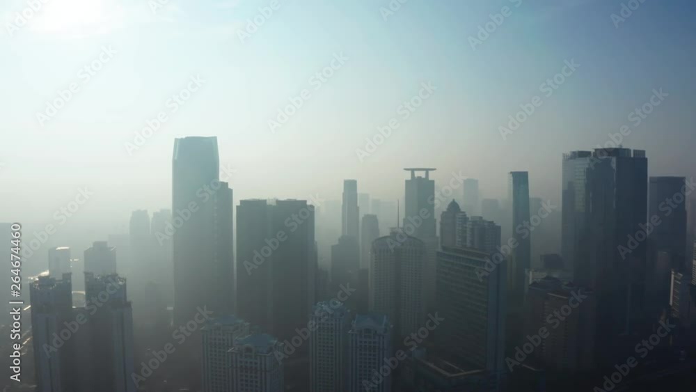 JAKARTA, Indonesia - April 25, 2019: Aerial landscape of Jakarta town with silhouette of modern office buildings covered by fog on the morning. Shot in 4k resolution from a drone flying forwards JAKARTA, Indonesia - April 25, 2019: Aerial landscape of Jakarta town with silhouette of modern office buildings covered by fog on the morning. Shot in 4k resolution from a drone flying forwards