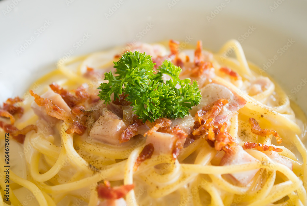 Spaghetti Carbonara with Bacon and Ham and Parsley and Mayonnaise Sauce Close up Center Spaghetti Carbonara with Bacon and Ham and Parsley and Mayonnaise Sauce Close up Center