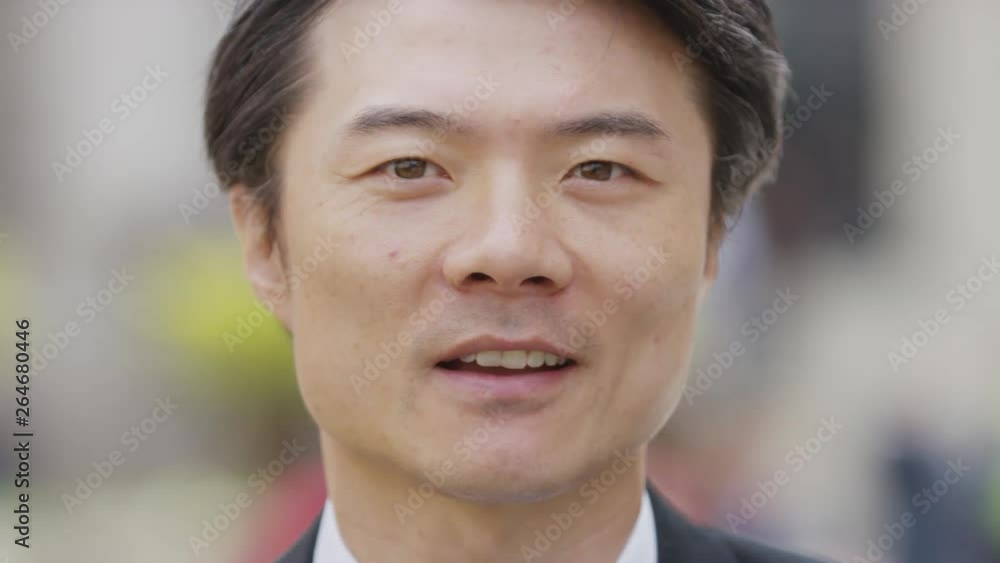 Close portrait of Asian male talking to camera, in slow motion Close portrait of Asian male talking to camera, in slow motion