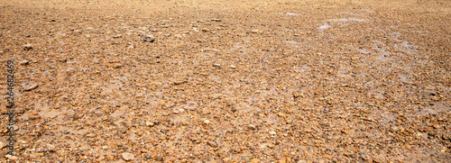  Coast, river bank,Sandy texture,Large sand with small stones, bright sunlight.  summer, beach.Morning sunrise at the pier Railay Bay, railay Beach railay Amphur Muang, Krabi Thailand