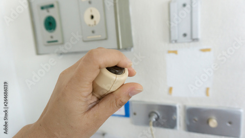 Patient  pressing hand on nurse call button emergency  with selective focus point Patient Safety Alarms.