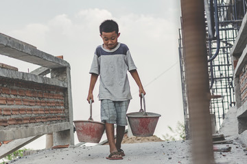 Children working at construction site for world day against child labour concept: