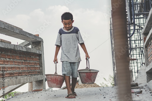 Fototapeta Children working at construction site for world day against child labour concept