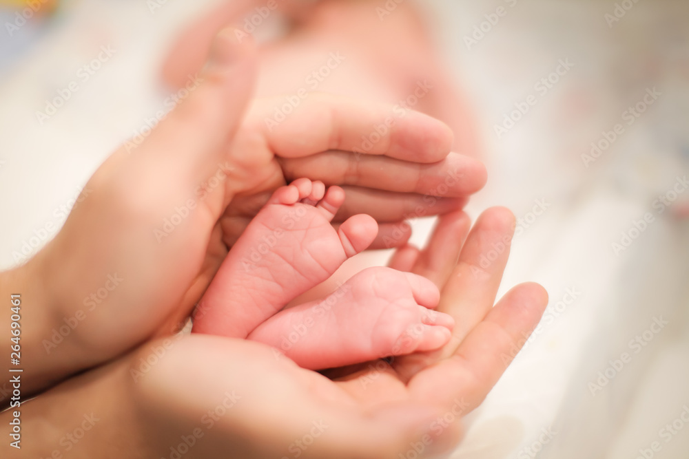 Baby little feet in father hands. Dad and his Child. Happy Family concept