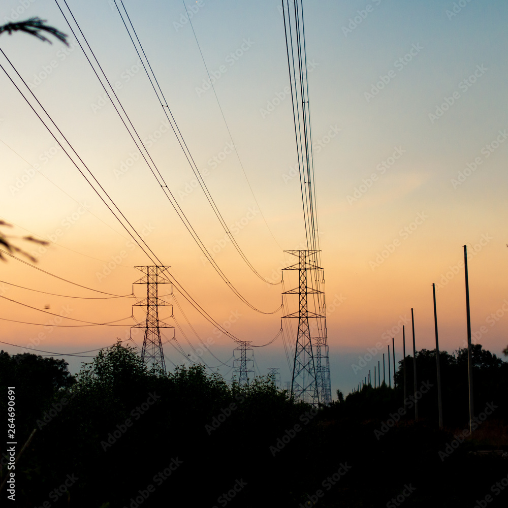 silhouette high voltage pole on sky sunset background.