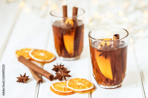 Mulled wine on white table in night celebration of New Year party and delicious Christmas drink