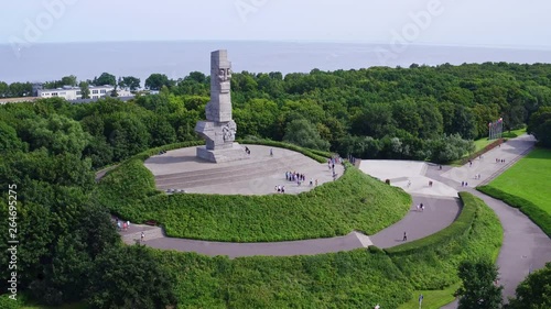 Drone footage showing Westerplatte Monument on a peninsula in Gdańsk harbor channel.