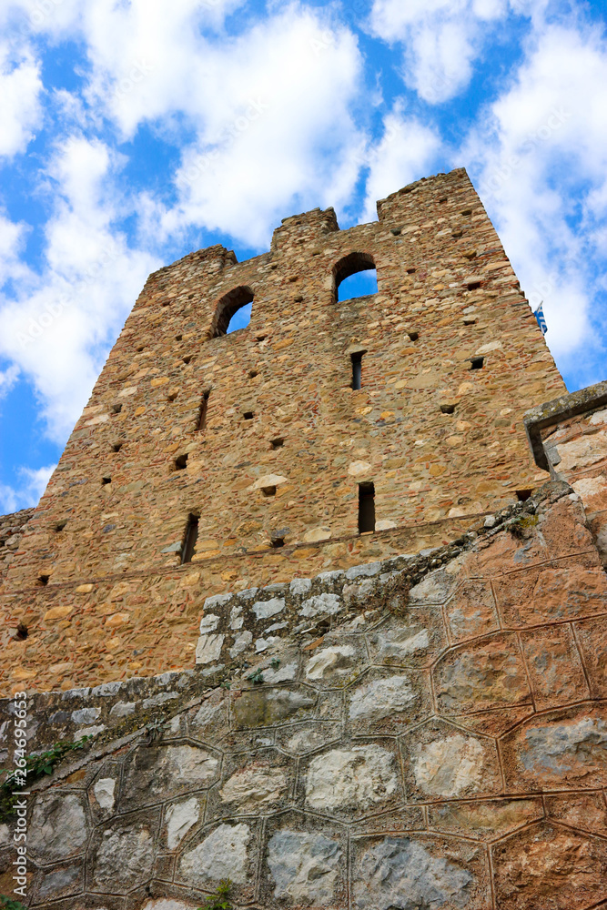 Stone wall of ruin of medieval ruin tower with blue sky on the background, abandoned byzantine town Mystras, Greece